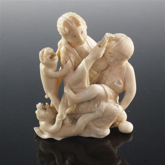 A Japanese ivory okimono of a mother suckling a child, Meiji period, 7.7cm